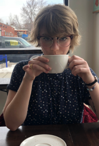Portrait of a woman with short hair holding a mug